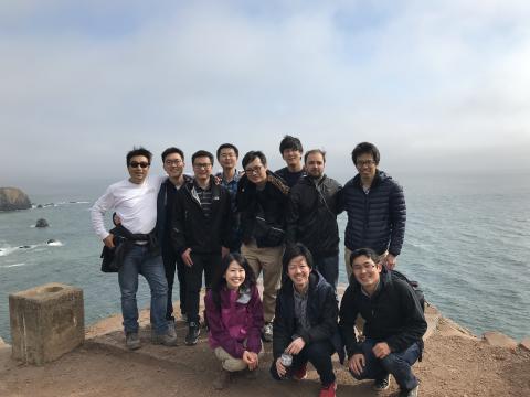 Kajimura lab huddled together on a cliff